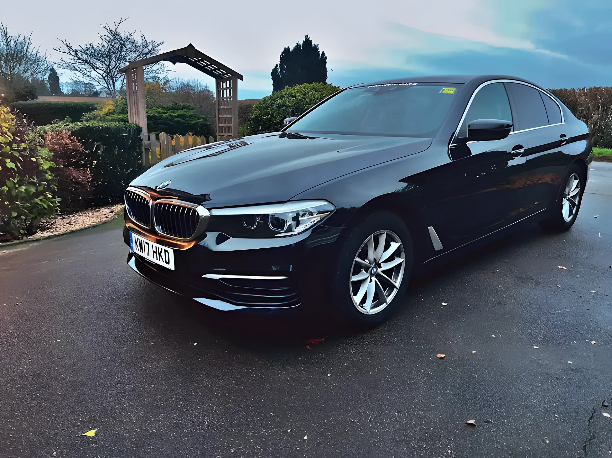 Black BMW 5 Series executive saloon on a driveway